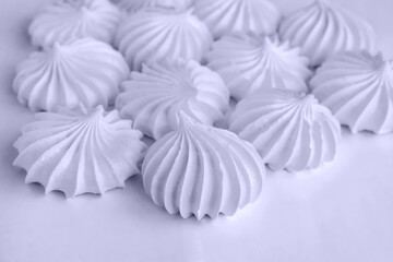 Obraz premium freshly baked meringue cookies on a light background. Beautiful meringue background closeup with blur