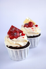 chocolate cupcakes with cream cheese frosting and festive decor. Valentine's day or birthday...