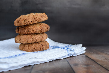 oatmeal cookies on a white towel on a dark rustic background. confectionery.