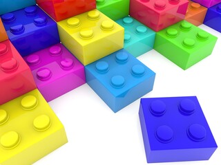 Colored toy bricks in the form of steps with a blue toy brick in the foreground