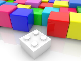 Colored cubes with a white toy brick in the foreground