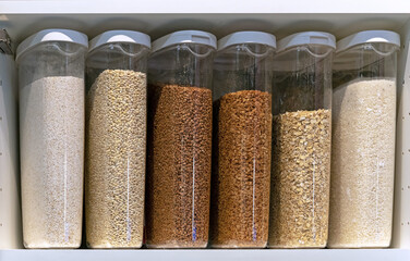 Plastic containers with various cereals and grains. Food storage concept.