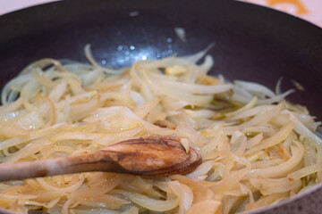 sliced onions fry in a pan
