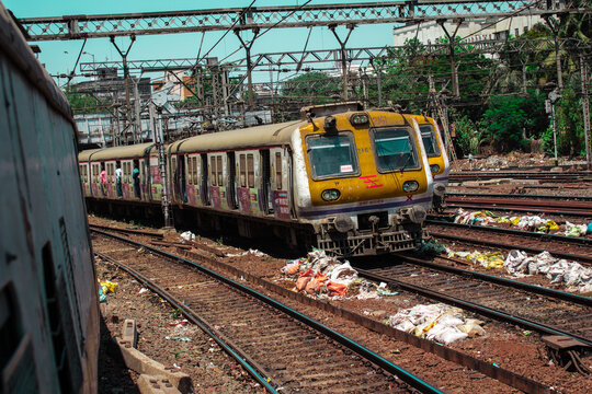 Electric commuter train on parallel railway tracks in India