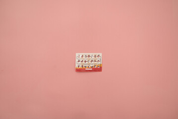 Female oral contraceptive pills blister on pink background. Women contraceptive hormonal birth...