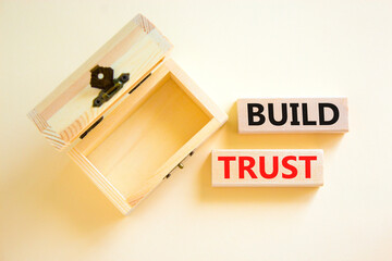Build trust symbol. Concept words Build trust on wooden blocks on a beautiful white table white background. Empthy wooden chest. Business and build trust concept, copy space.
