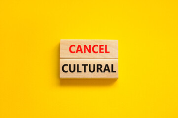 Cancel cultural symbol. Concept words Cancel cultural on wooden blocks on a beautiful yellow table...