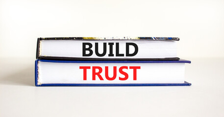 Build trust symbol. Concept words Build trust on books on a beautiful white table white background. Business and build trust concept, copy space.