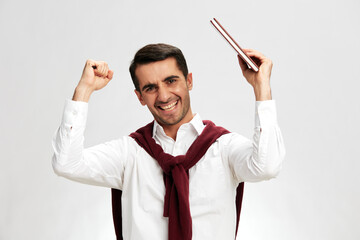 man in a white shirt sweater on the shoulders fun moodnotebook posing isolated background