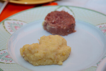 plate of cotechino and puree closeup on table