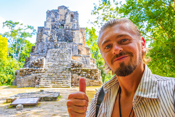 Fototapeta premium Tourist guide ancient Mayan site temple ruins pyramids Muyil Mexico.