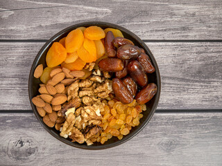 Nuts and dried fruits. Walnuts, almonds, dried apricots, raisins and dates. Healthy food and snacks. Oriental sweets