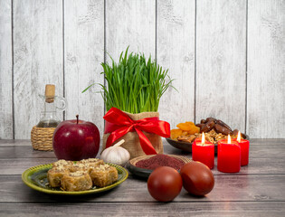 Obraz na płótnie Canvas Festive table in honor of Navruz. Wheat with a red ribbon, the traditional holiday of the vernal equinox Nawruz