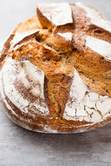 Gold rustic crusty loaves of bread and buns on wooden background. Still life captured from above top view, flat lay.
