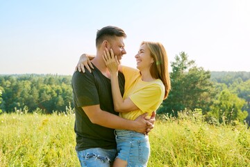 Outdoor portrait of happy middle age couple in love embracing