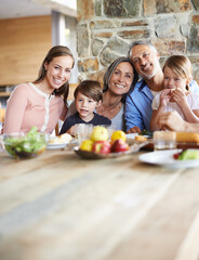 Treasured moments with the grandkids. A portrait of a happy multi-generational family sitting at a...