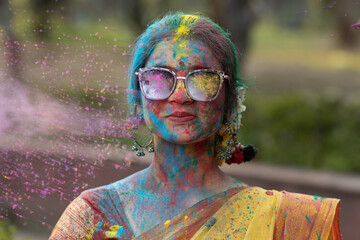 Holi festival of color, Splashing dry organic color or colour or gulal or abeer or Holi powder on a...