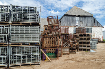 Old farmstead with boxes stacked in a pile.