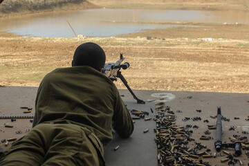 A soldier fires a machine gun israel . High quality photo