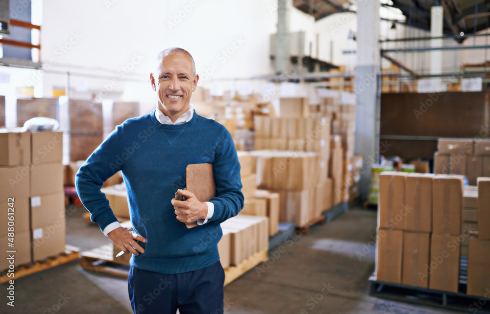 Wall mural Ive got your shipment ready for transport. Portrait of a mature man standing in a distribution warehouse.