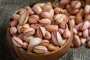 Close-up roasted pistachios in a bamboo bowl. Nuts from Gaziantep-Turkey region