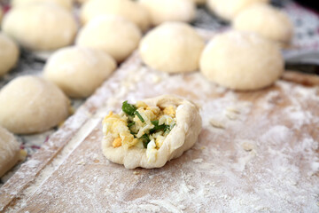 grandma cooks pies from fluffy dough for grandchildren