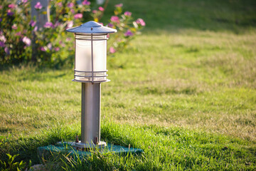 Outdoor lamp on yard lawn for garden lighting in summer park