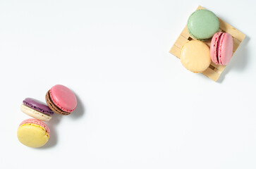Sweet colorful macarons isolated on white background. Tasty colorful macaroons. Top view.
