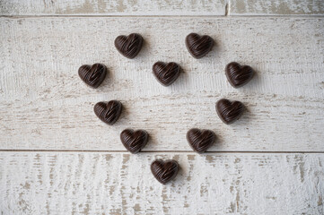 Heart made of dark chocolate on wooden table