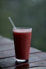 Strawberry juice in rain nature background view