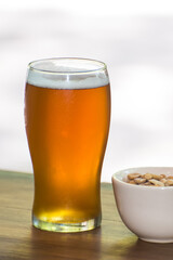 craft beer next to salted peanuts