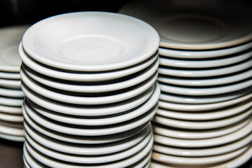 clean dishes from a restaurant on top of each other