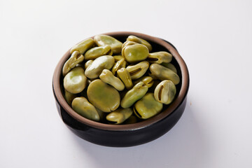 Broad beans with cheese, traditional Ecuadorian appetizer served in a typical deep dish with a white background
