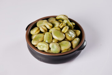 Broad beans with cheese, traditional Ecuadorian appetizer served in a typical deep dish with a white background
