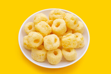 Roller corn snack on yellow background.