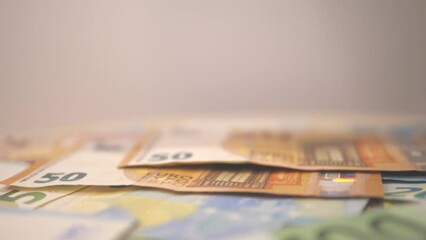 Euro bills falling in slow motion on the table. Euro banknotes falling.