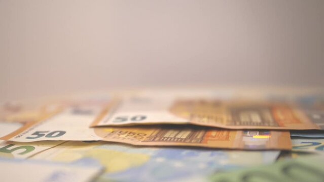 Euro bills falling in slow motion on the table. Euro banknotes falling.