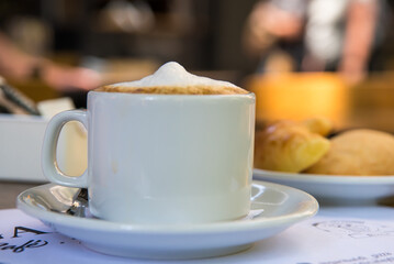 coffee with milk, croissants and sweeteners