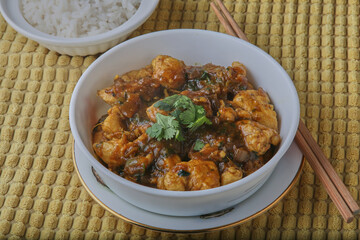 Chicken curry with rice,garnished with lime wedge and mayonnaise.