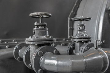 Close-up detail of two control valves and pipes in power station