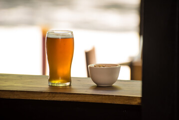 craft beer next to salted peanuts