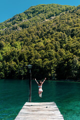 Fototapeta na wymiar girl jumps to the lake