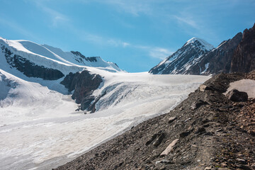 Scenic mountain landscape with large glacier in sunlight. Awesome snowy scenery with glacial tongue...