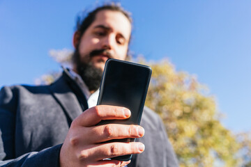 young business man looking phone near to office