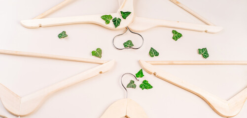 Hangers with plants on white background with copy space.Conscious and environmentally friendly consupmtion in shopping.Zero waste.Shopping,sale,promo, concept.Top view flat lay copy space.