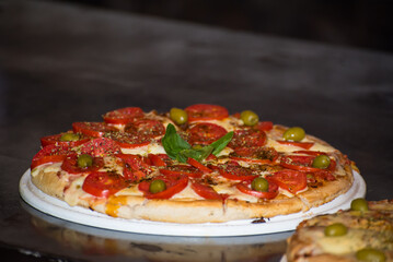 homemade pizza over a restaurant counter