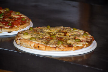 homemade pizza over a restaurant counter