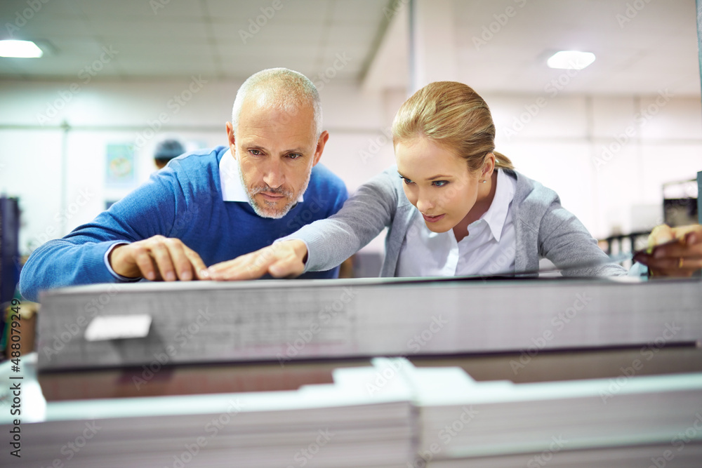 Aufkleber quality assurance throughout the printing process. two publishers assessing the quality of printed w