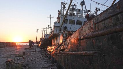 Old abandoned fishing boat at sunset