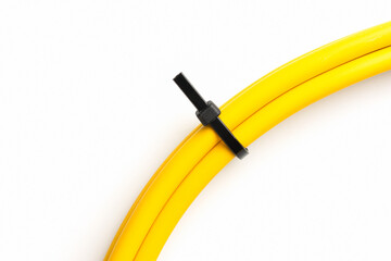 black cable ties on yellow cable isolated on white background. object picture for graphic designer